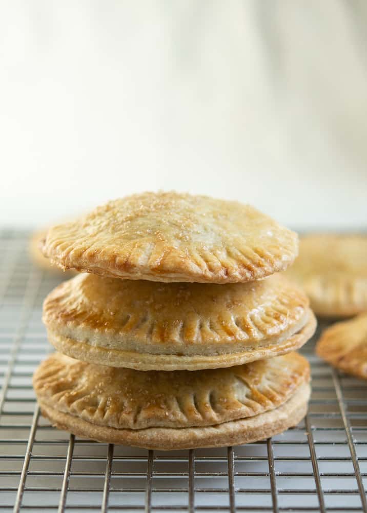 Pumpkin Hand Pies stacked up three tall on baking rack