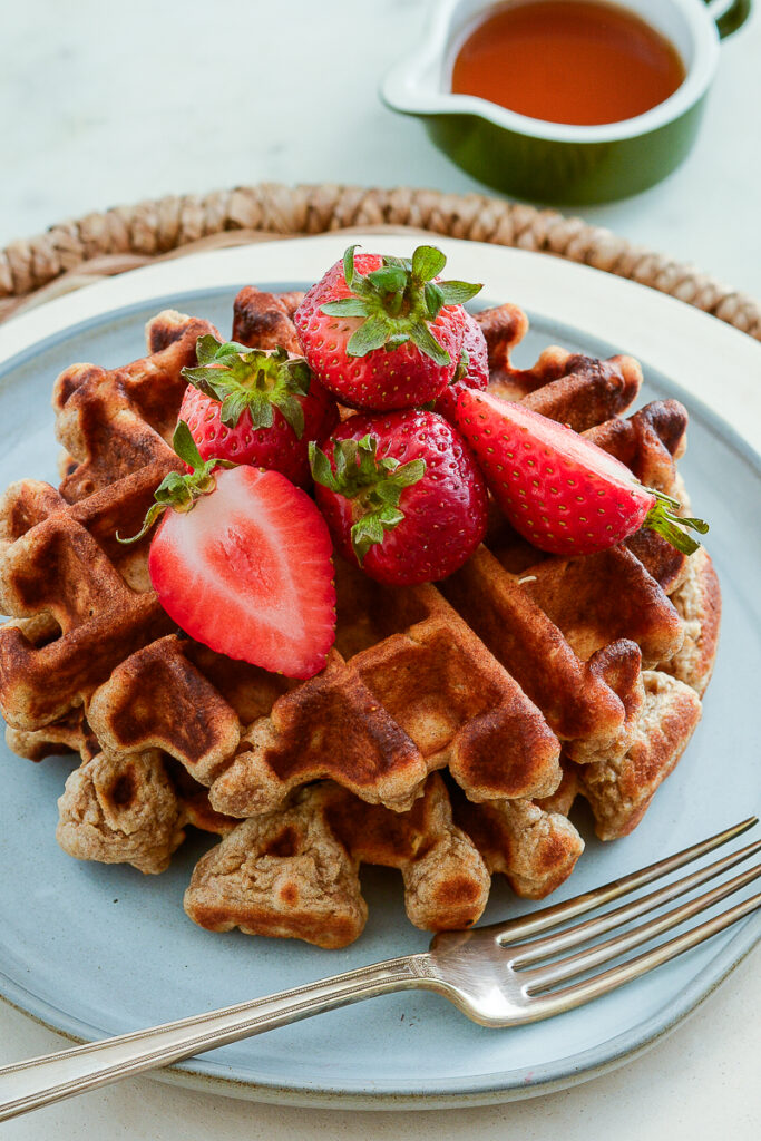 sourdough whole grain waffles with strawberries and syrup