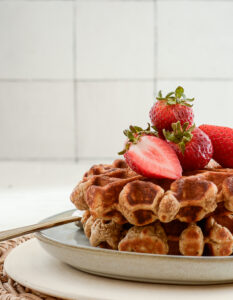 side angle shot of sourdough whole grain waffles on a plate